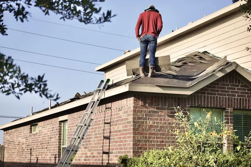 Professional roofer working on a residential roof in Chalfont
